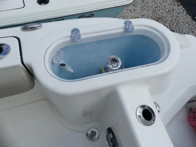 Slide: The Image of 2025 Key West 244 CC boat livewell with blue interior and stainless steel fittings. - 12