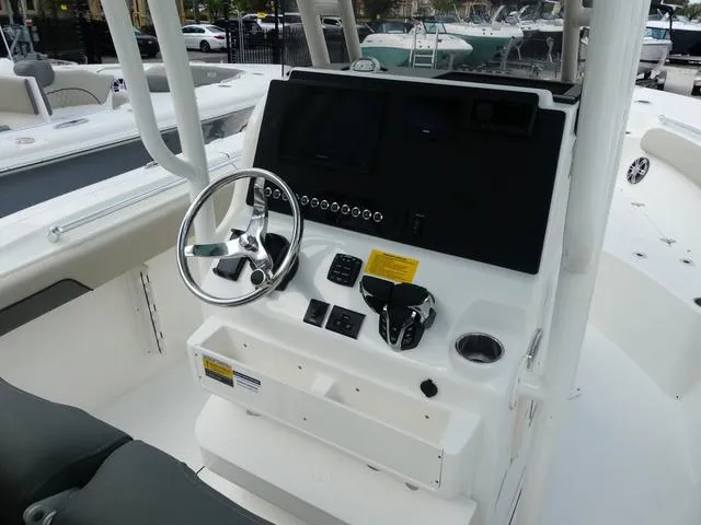Slide: The Image of 2025 Key West 244 CC boat console with steering wheel and controls. - 15