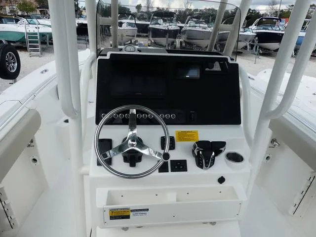 Slide: The Image of 2025 Key West 244 CC boat dashboard with steering wheel and controls. - 16