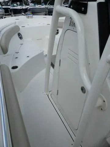 Slide: The Image of 2025 Key West 244 CC boat interior with white seating and console. - 22