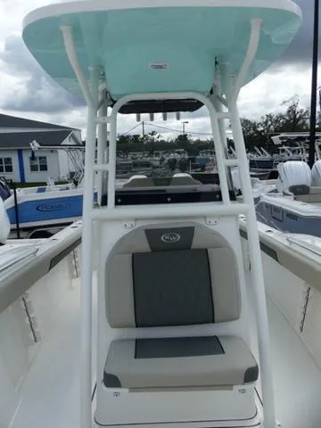 Slide: The Image of 2025 Key West 244 CC boat with seating and T-top in a marina setting. - 26