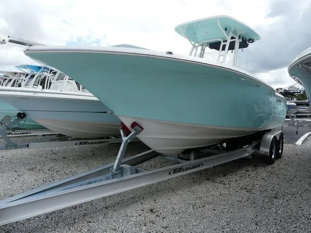 Slide: The Image of 2025 Key West 244 CC boat on trailer, light blue hull, parked outdoors. - 3