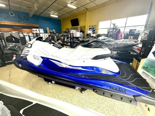 Slide: The Image of 2025 Yamaha WaveRunner GP in showroom, blue and white design, displayed indoors. - 3