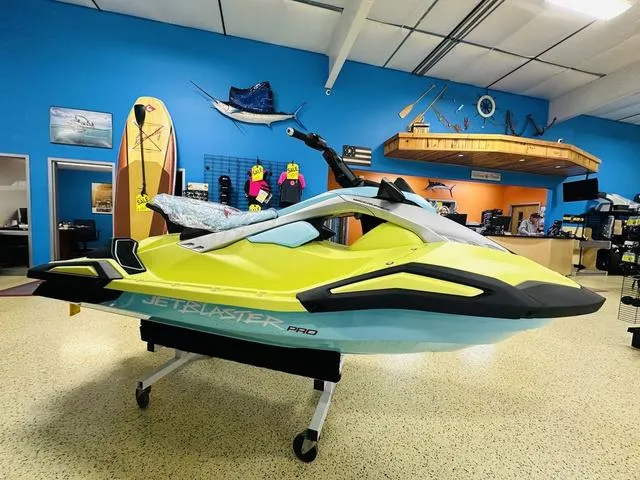Slide: The Image of 2025 Yamaha WaveRunner JetBlaster in showroom, vibrant yellow and blue design. - 10
