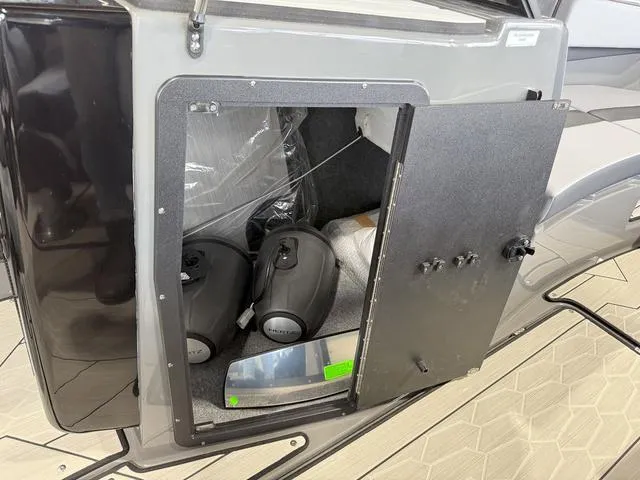 Slide: The Image of Storage compartment of 2025 Yamaha Boats 222XE with equipment inside. - 18