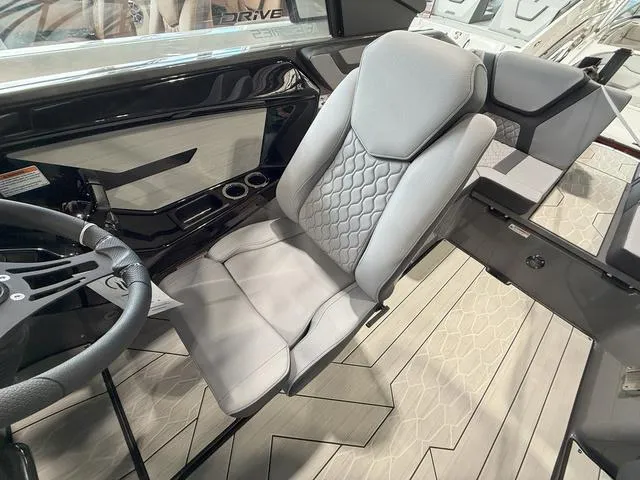 Slide: The Image of 2025 Yamaha Boats 222XE interior with sleek captain's chair and modern dashboard design. - 10
