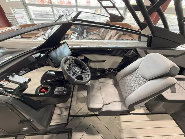 Slide: The Image of Interior of 2025 Yamaha Boats 222XE, featuring modern dashboard and comfortable seating. - 9