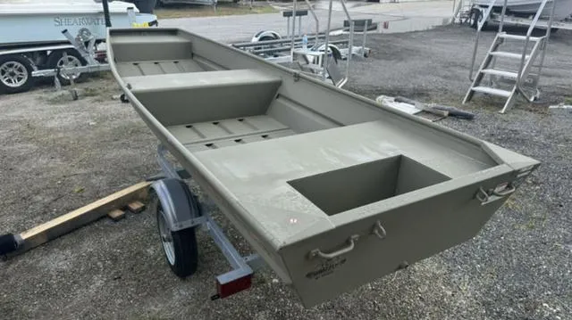 Slide: The Image of 2025 Tracker 1236 JON boat on trailer, parked outdoors. - 3