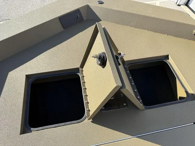 Slide: The Image of Avid 20 Rogue SC 2025 boat storage compartments with open lids. - 10