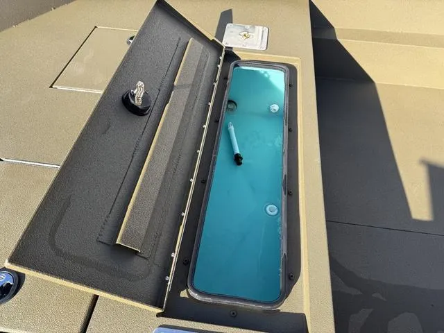 Slide: The Image of Open storage compartment on 2025 Avid 20 Rogue SC boat with water inside. - 12