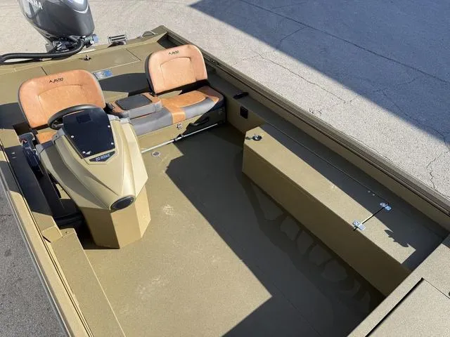 Slide: The Image of 2025 Avid 20 Rogue SC boat interior with tan seats and steering console. - 13