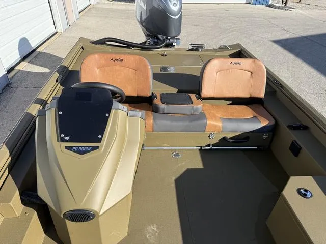 Slide: The Image of 2025 Avid 20 Rogue SC boat interior with tan seats and steering console. - 16