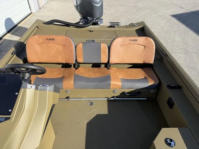 Slide: The Image of 2025 Avid 20 Rogue SC boat interior with tan and black seating. - 17