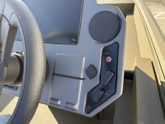 Slide: The Image of Dashboard of 2025 Avid 20 Rogue SC boat with steering wheel and controls. - 20
