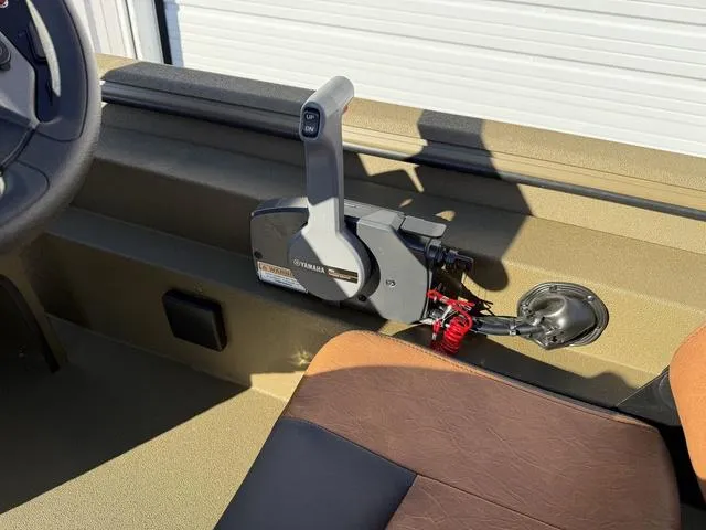 Slide: The Image of Interior of 2025 Avid 20 Rogue SC boat with Yamaha throttle control. - 21