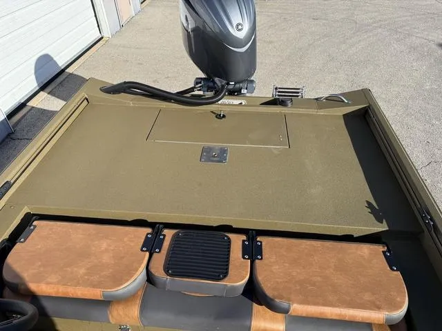 Slide: The Image of Avid 20 Rogue SC 2025 boat with motor, brown seating, and storage compartments. - 23