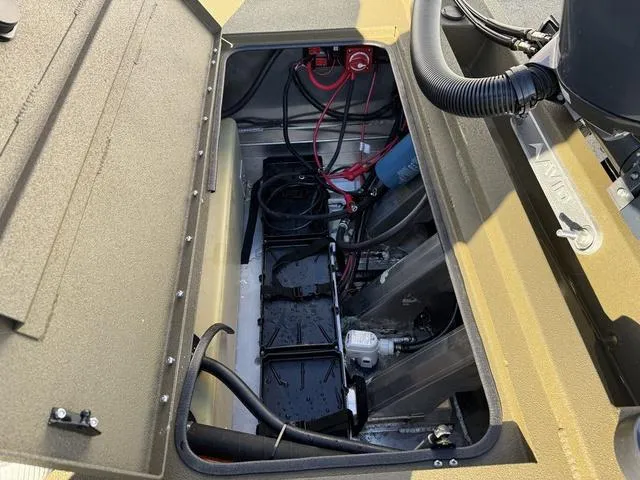 Slide: The Image of Open engine compartment of 2025 Avid 20 Rogue SC boat, showing wiring and components. - 24