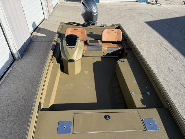 Slide: The Image of 2025 Avid 20 Rogue SC boat with tan interior and outboard motor. - 7