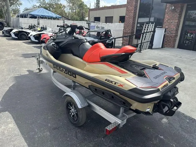 Slide: The Image of 2025 Sea-Doo Waverunner PWC RXT X on trailer, parked outdoors. - 5