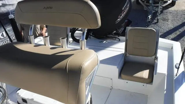 Slide: The Image of Avid 23 FS 2021 boat interior with beige seating and rod holders. - 11