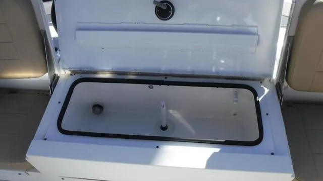Slide: The Image of Open storage compartment on 2021 Avid 23 FS boat. - 12