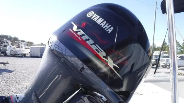 Slide: The Image of Yamaha VMAX outboard motor on 2021 Avid 23 FS boat, parked in a marina. - 17