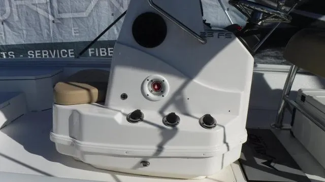 Slide: The Image of 2021 Avid 23 FS boat console with controls and seating. - 19