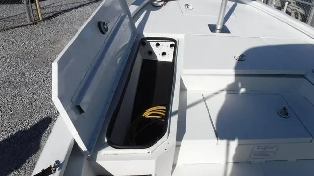 Slide: The Image of Open storage compartment on 2021 Avid 23 FS boat deck. - 5