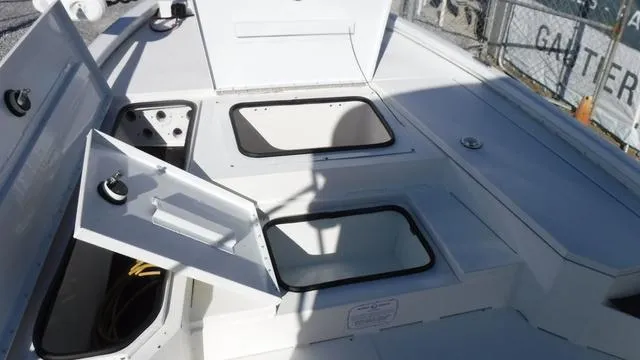 Slide: The Image of 2021 Avid 23 FS boat deck with open storage compartments. - 6
