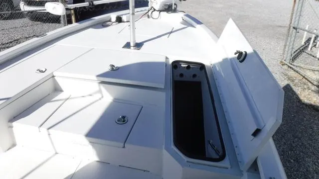 Slide: The Image of 2021 Avid 23 FS boat deck with open storage compartment. - 7