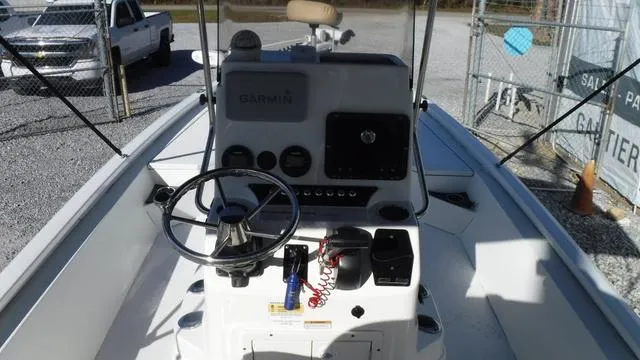 Slide: The Image of 2021 Avid 23 FS boat console with steering wheel and Garmin navigation system. - 9