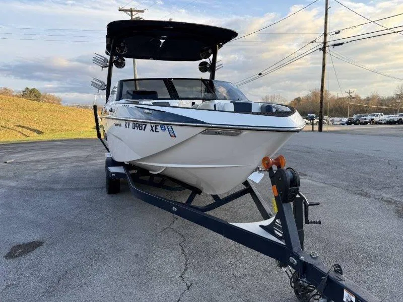 Slide: The Image of 2021 Malibu 25 LSV boat on trailer in parking lot. - 19