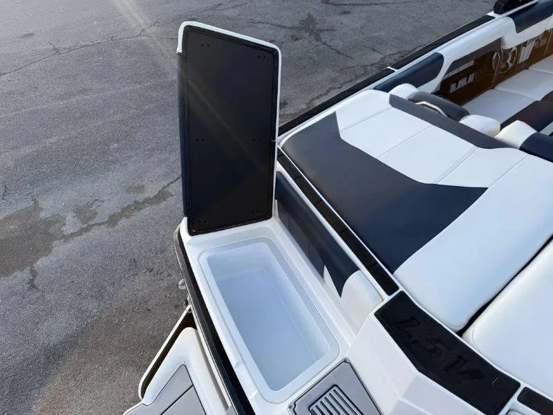 Slide: The Image of 2021 Malibu 25 LSV boat interior with open storage compartment. - 26