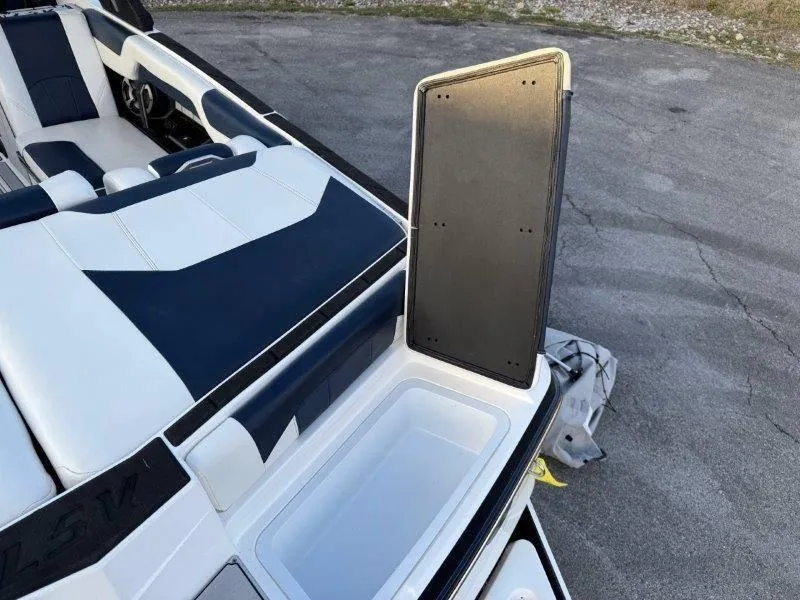 Slide: The Image of 2021 Malibu 25 LSV boat interior with open storage compartment. - 27