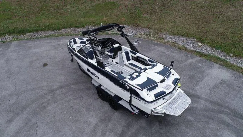 Slide: The Image of 2021 Malibu 25 LSV boat on trailer, aerial view, parked on concrete surface. - 3