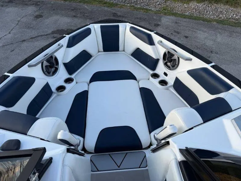 Slide: The Image of 2021 Malibu 25 LSV boat interior with blue and white seating. - 31