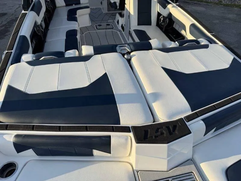 Slide: The Image of 2021 Malibu 25 LSV boat interior with white and navy seating. - 38