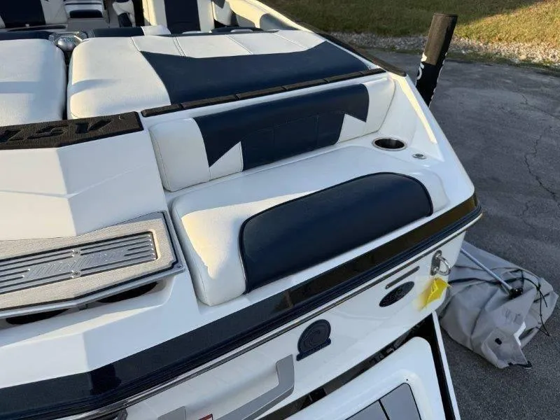 Slide: The Image of 2021 Malibu 25 LSV boat interior with white and navy seating. - 39