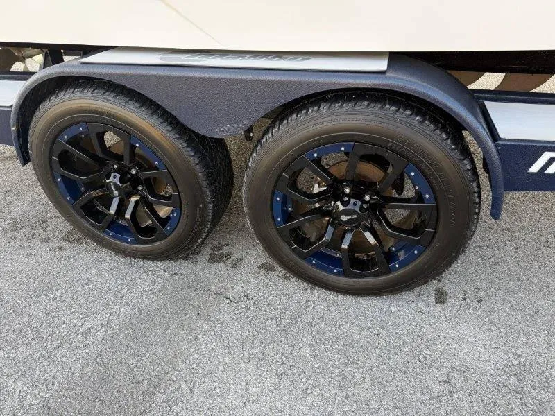 Slide: The Image of 2021 Malibu 25 LSV trailer with stylish black and blue wheels. - 44