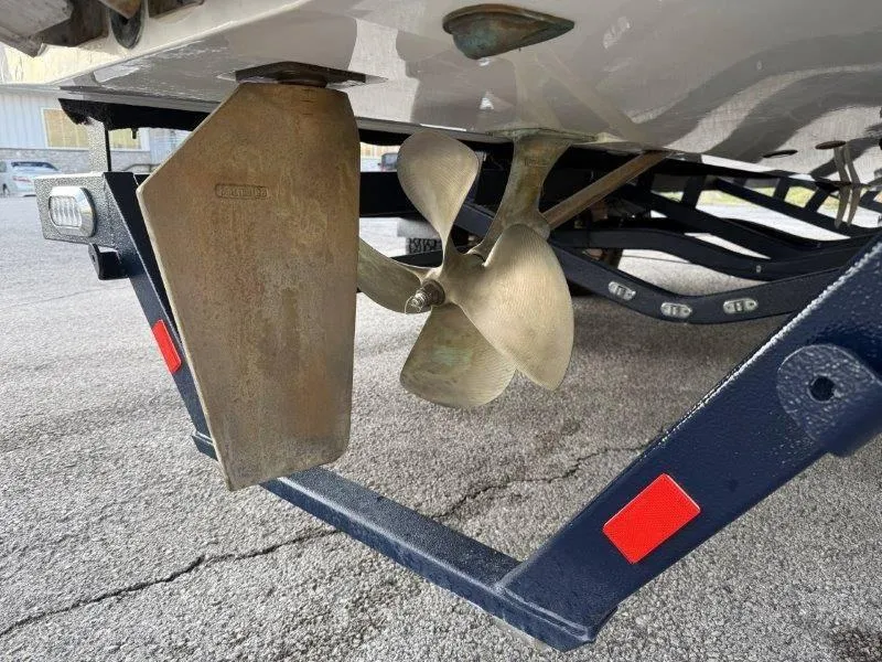 Slide: The Image of Close-up of 2021 Malibu 25 LSV boat propeller and rudder on trailer. - 45