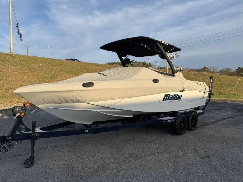 Slide: The Image of 2021 Malibu 25 LSV boat on trailer with cover, parked outdoors. - 47