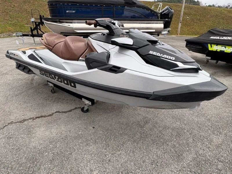 Slide: The Image of 2018 Sea-Doo GTX Limited 230 Sound jet ski on display in a parking lot. - 3