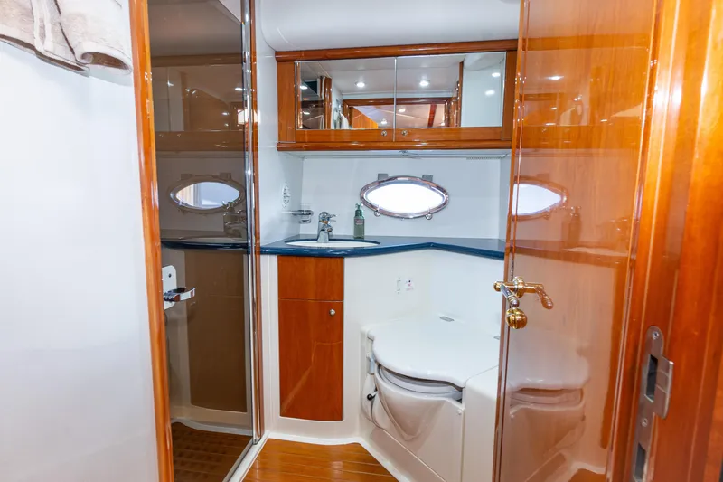 Slide: The Image of Luxurious bathroom in 2003 Sunseeker Predator 60 yacht with wood accents and modern fixtures. - 10