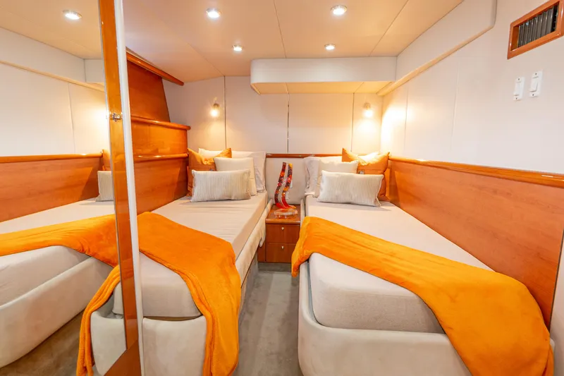 Slide: The Image of Luxurious twin cabin in 2003 Sunseeker Predator 60 yacht with orange accents. - 8