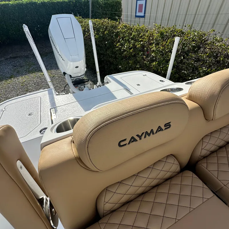 Slide: The Image of 2025 Caymas 28 HB boat interior with tan quilted seats and motor. - 12