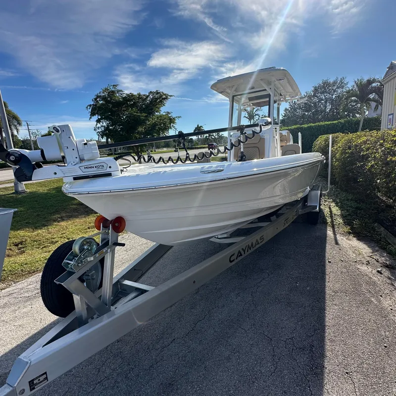 Slide: The Image of 2025 Caymas 28 HB boat on trailer under sunny sky. - 15