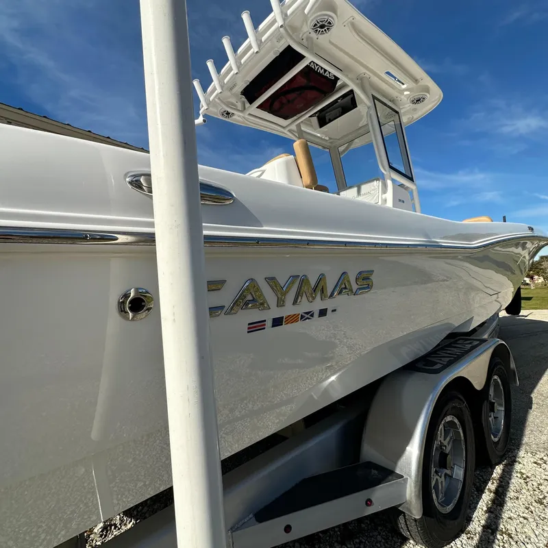 Slide: The Image of 2025 Caymas 28 HB boat on trailer under clear blue sky. - 3