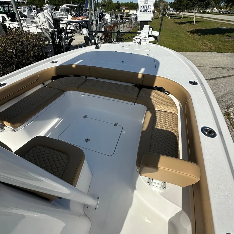 Slide: The Image of 2025 Caymas 28 HB boat interior with tan seating at Naples Marina. - 6