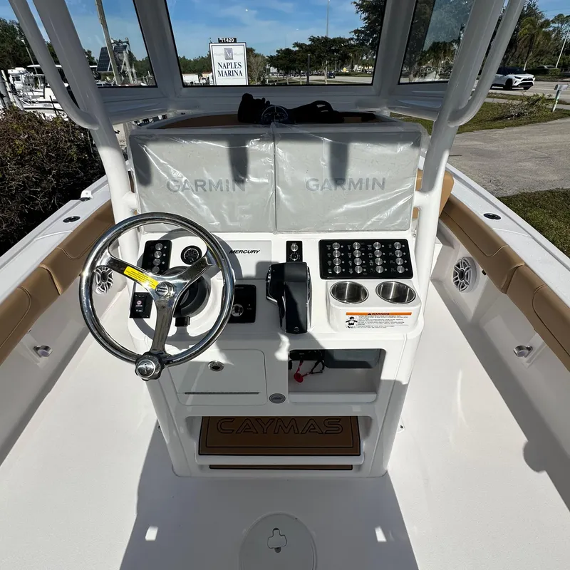 Slide: The Image of 2025 Caymas 28 HB boat console with Garmin displays and steering wheel. - 7
