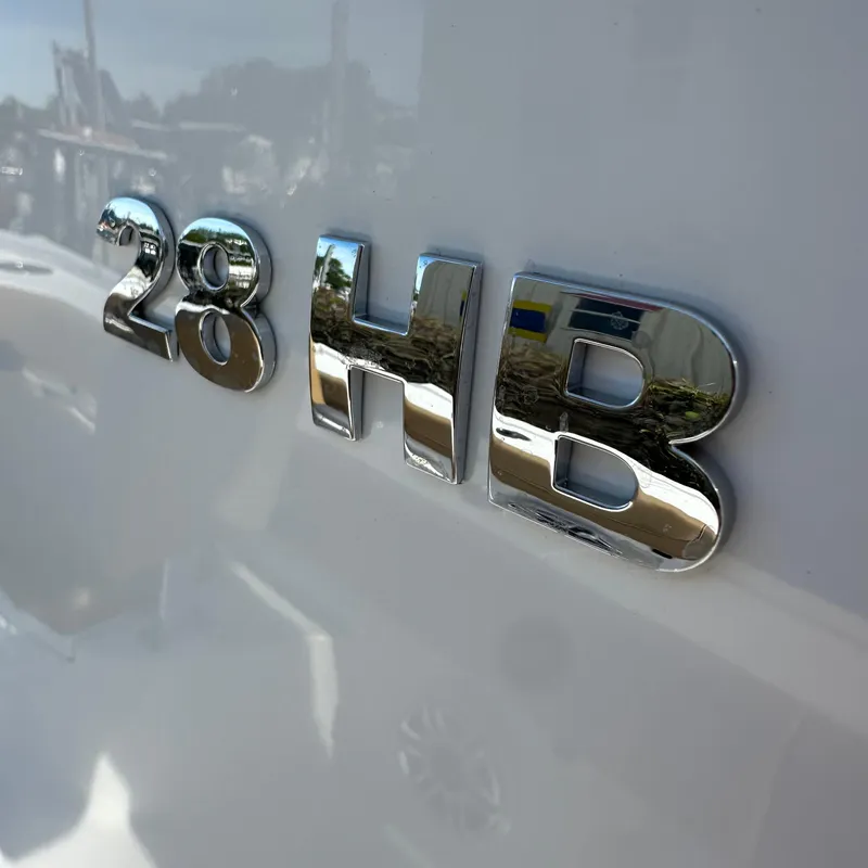 Slide: The Image of Chrome "28 HB" emblem on 2025 Caymas boat. - 8